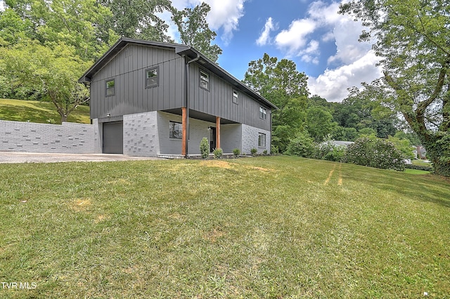 1091 Long Crescent Dr, Bristol, VA 24201 - view of side of home with an attached garage, brick siding, and a yard