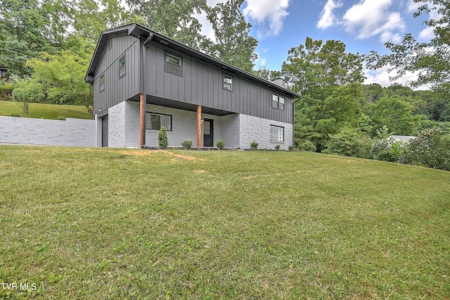 1091 Long Crescent Dr, Bristol, VA 24201 - view of front of property with a garage, a front lawn, brick siding, and board and batten siding