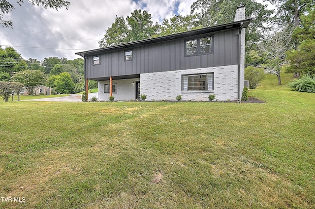 1091 Long Crescent Dr, Bristol, VA 24201 - view of front of home with brick siding, a chimney, a front lawn, and concrete driveway