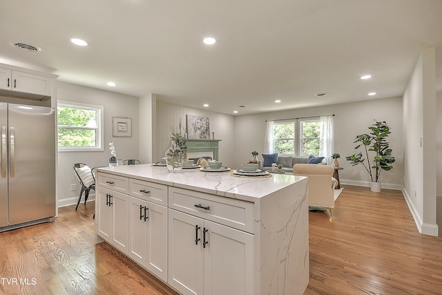 1091 Long Crescent Dr, Bristol, VA 24201 - kitchen featuring freestanding refrigerator, white cabinets, light wood-style floors, healthy amount of natural light, and recessed lighting