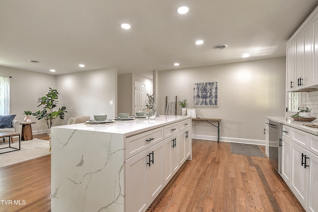 1091 Long Crescent Dr, Bristol, VA 24201 - kitchen featuring recessed lighting, white cabinets, light wood-style floors, stainless steel dishwasher, and light stone counters