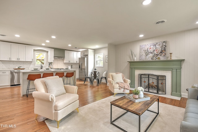 1091 Long Crescent Dr, Bristol, VA 24201 - living room with healthy amount of natural light, light wood-type flooring, recessed lighting, and a fireplace