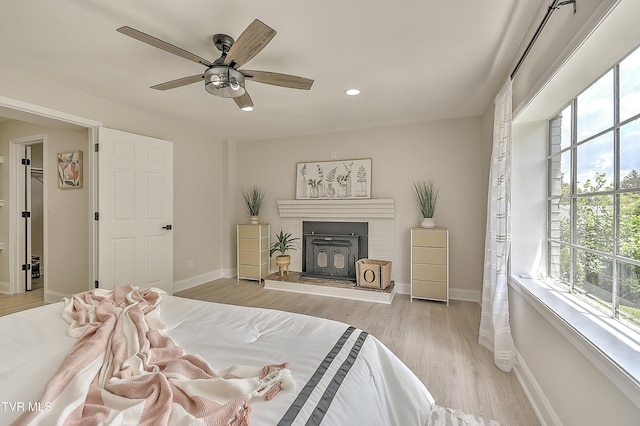 1091 Long Crescent Dr, Bristol, VA 24201 - bedroom featuring multiple windows, recessed lighting, wood finished floors, ceiling fan, and a fireplace