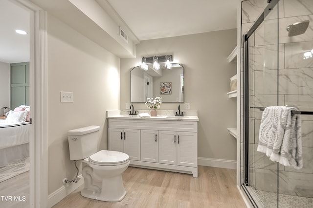 1091 Long Crescent Dr, Bristol, VA 24201 - bathroom featuring wood finished floors, double vanity, connected bathroom, and a stall shower