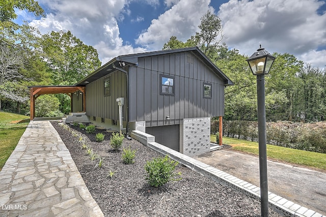 1091 Long Crescent Dr, Bristol, VA 24201 - view of side of property with board and batten siding, an attached garage, driveway, and brick siding