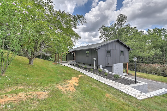1091 Long Crescent Dr, Bristol, VA 24201 - rear view of property with a garage, a yard, board and batten siding, and driveway