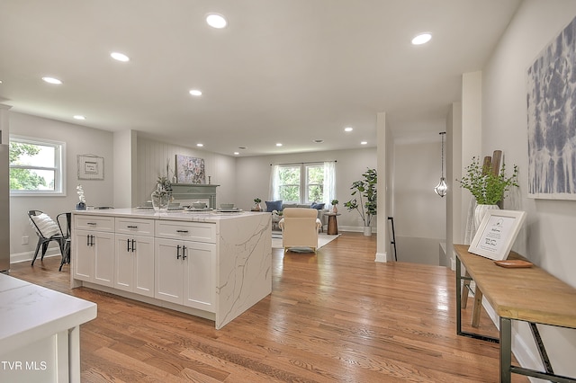 1091 Long Crescent Dr, Bristol, VA 24201 - kitchen featuring recessed lighting, a kitchen island with sink, white cabinetry, light wood-style floors, and open floor plan
