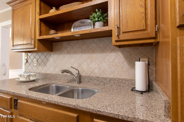 184 Center St, Bristol, VA 24201 - kitchen with open shelves, tasteful backsplash, brown cabinetry, and light stone countertops