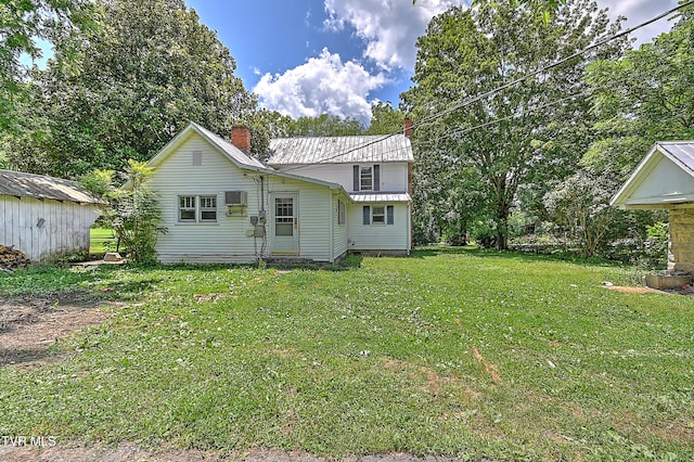 301 Keenburg Rd, Bluff City, TN 37618 - rear view of house with a chimney, a metal roof, a yard, and an outbuilding