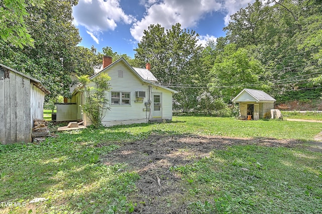 301 Keenburg Rd, Bluff City, TN 37618 - back of property with a chimney, a lawn, an outbuilding, and a wall mounted AC