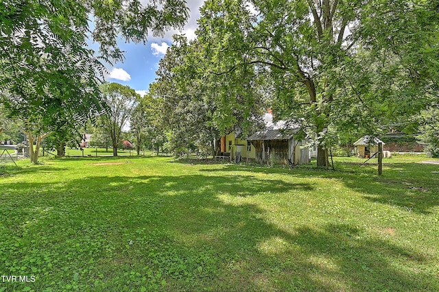 301 Keenburg Rd, Bluff City, TN 37618 - view of green lawn with an outdoor structure