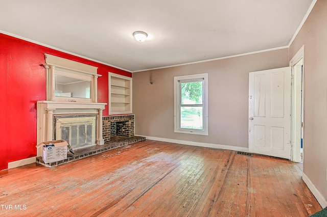 301 Keenburg Rd, Bluff City, TN 37618 - unfurnished living room featuring hardwood / wood-style flooring, crown molding, a brick fireplace, and built in features
