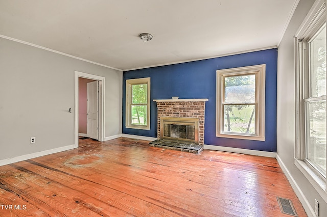 301 Keenburg Rd, Bluff City, TN 37618 - unfurnished living room with crown molding, plenty of natural light, hardwood / wood-style floors, and a brick fireplace