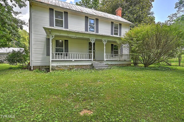 301 Keenburg Rd, Bluff City, TN 37618 - view of front facade with a porch, a front lawn, a chimney, and a metal roof