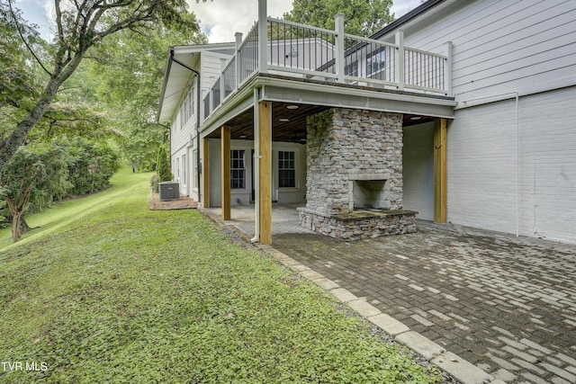 2 Longview Ln, Kingsport, TN 37660 - view of side of home with an outdoor stone fireplace, a patio, a yard, stone siding, and a wooden deck