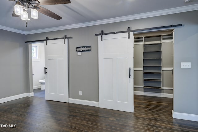 2 Longview Ln, Kingsport, TN 37660 - unfurnished bedroom featuring a barn door, a closet, hardwood / wood-style floors, crown molding, and a spacious closet