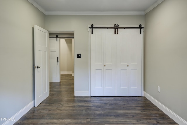 2 Longview Ln, Kingsport, TN 37660 - unfurnished bedroom featuring a barn door, dark wood-type flooring, crown molding, and a closet