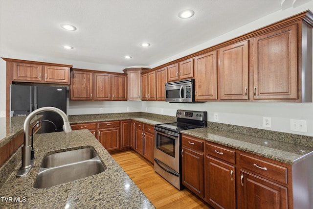 1824 King College Rd Unit E1, Bristol, TN 37620 - kitchen featuring stainless steel appliances, recessed lighting, light wood-style flooring, dark stone countertops, and brown cabinets
