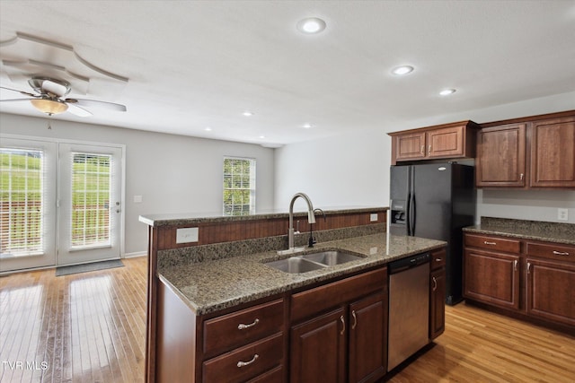 1824 King College Rd Unit E1, Bristol, TN 37620 - kitchen featuring stainless steel dishwasher, a kitchen island with sink, light wood-style floors, ceiling fan, and dark stone counters