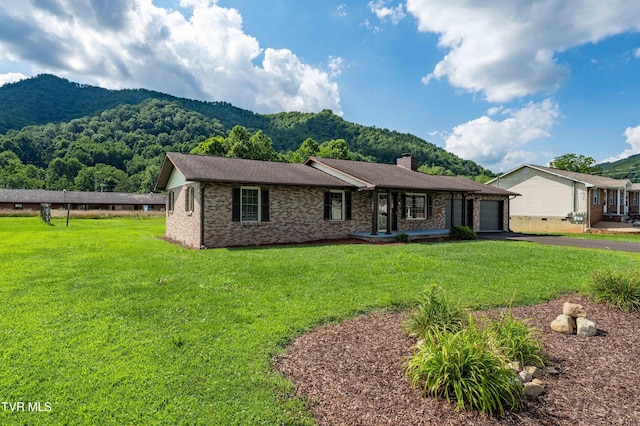 157 Spring St, Hampton, TN 37658 - ranch-style house featuring asphalt driveway, a garage, a mountain view, brick siding, and a front lawn