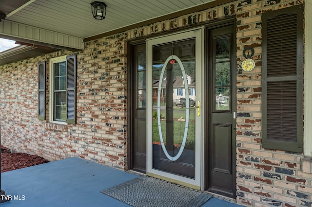 157 Spring St, Hampton, TN 37658 - doorway to property featuring brick siding and covered porch