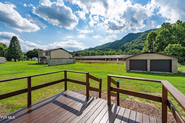 157 Spring St, Hampton, TN 37658 - deck with a garage, a mountain view, an outdoor structure, and a lawn