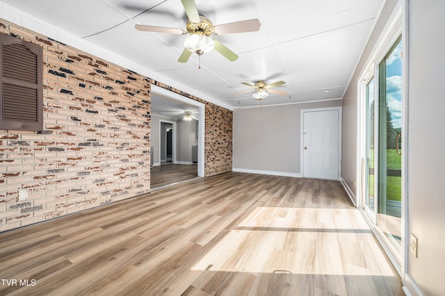 157 Spring St, Hampton, TN 37658 - empty room with brick wall, ceiling fan, and wood finished floors