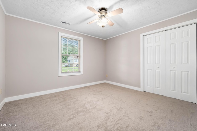 157 Spring St, Hampton, TN 37658 - unfurnished bedroom with ornamental molding, carpet flooring, a closet, a textured ceiling, and a ceiling fan