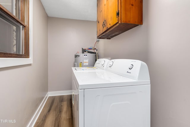 157 Spring St, Hampton, TN 37658 - washroom with washing machine and clothes dryer, water heater, cabinet space, and dark wood-style floors
