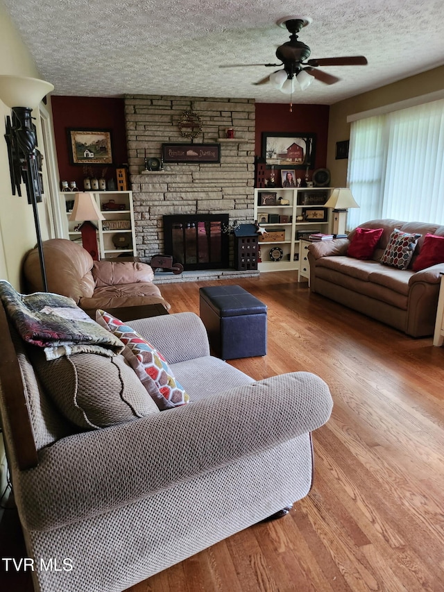 2020 Oakland St, Kingsport, TN 37660 - living room with a ceiling fan, wood finished floors, a textured ceiling, and a fireplace