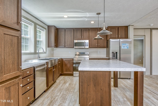 8492 Reedy Creek Rd, Bristol, VA 24202 - kitchen with stainless steel appliances, light wood-style floors, a center island, a breakfast bar area, and pendant lighting