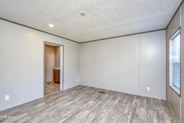 8492 Reedy Creek Rd, Bristol, VA 24202 - empty room with wood finished floors, a textured ceiling, plenty of natural light, and a decorative wall