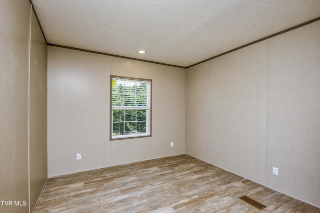 8492 Reedy Creek Rd, Bristol, VA 24202 - empty room with wood finished floors, a textured ceiling, and ornamental molding