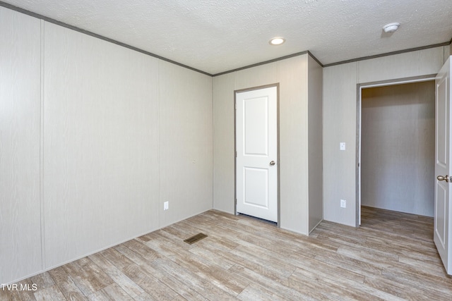 8492 Reedy Creek Rd, Bristol, VA 24202 - unfurnished bedroom featuring light wood-style flooring, a textured ceiling, and ornamental molding