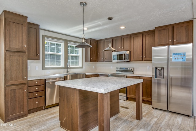 8492 Reedy Creek Rd, Bristol, VA 24202 - kitchen with stainless steel appliances, light wood-type flooring, light countertops, recessed lighting, and a kitchen island