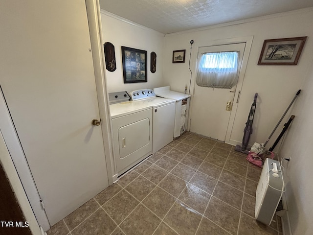 406 NE Mason Ave, Wise, VA 24293 - laundry area featuring washing machine and clothes dryer, cabinet space, crown molding, and dark tile patterned flooring