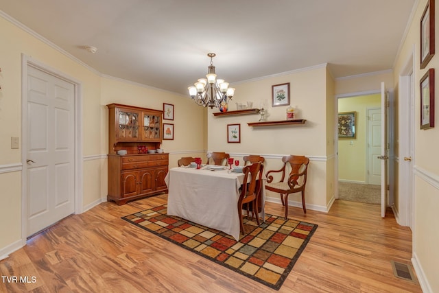 236 Wadlow Gap Rd, Kingsport, TN 37660 - dining area featuring light wood-style floors, a chandelier, and ornamental molding