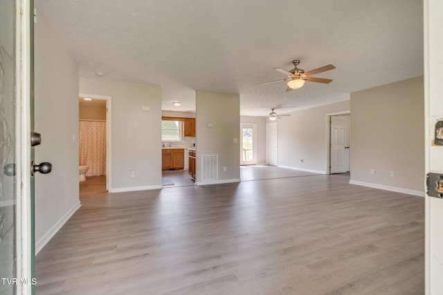 6215 Snapps Ferry Rd, Afton, TN 37616 - unfurnished living room with ceiling fan, light wood finished floors, and a textured ceiling