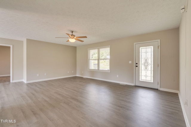 6215 Snapps Ferry Rd, Afton, TN 37616 - unfurnished living room with a textured ceiling, a ceiling fan, and wood finished floors