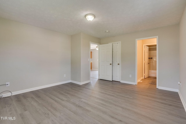 6215 Snapps Ferry Rd, Afton, TN 37616 - unfurnished bedroom featuring wood finished floors, a textured ceiling, and ensuite bathroom
