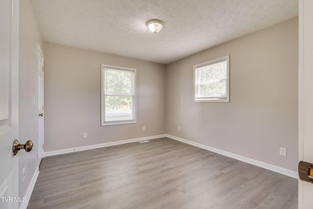 6215 Snapps Ferry Rd, Afton, TN 37616 - spare room featuring wood finished floors and a textured ceiling
