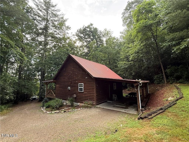 912 Hawkins Rd, Laurel Bloomery, TN 37680 - view of side of home with dirt driveway, a metal roof, and a yard