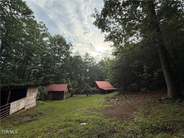 912 Hawkins Rd, Laurel Bloomery, TN 37680 - view of green lawn featuring a storage shed and a view of trees