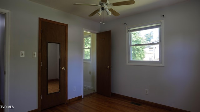 221 Timber Ridge Rd, Jonesborough, TN 37659 - unfurnished bedroom with multiple windows, dark wood-type flooring, and ceiling fan
