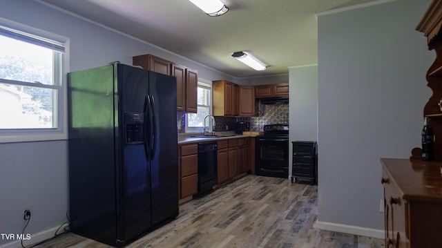 221 Timber Ridge Rd, Jonesborough, TN 37659 - kitchen with black appliances, tasteful backsplash, light wood-type flooring, under cabinet range hood, and a textured ceiling