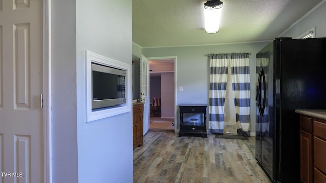 221 Timber Ridge Rd, Jonesborough, TN 37659 - kitchen with freestanding refrigerator, stainless steel microwave, light wood-type flooring, and a textured ceiling