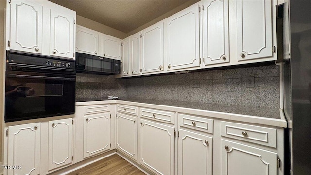 542 Sigman Hollow Rd, Bluff City, TN 37618 - kitchen featuring black appliances, backsplash, white cabinetry, and dark countertops
