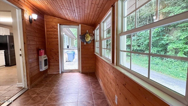 542 Sigman Hollow Rd, Bluff City, TN 37618 - doorway with vaulted ceiling, wooden walls, heating unit, and wood ceiling