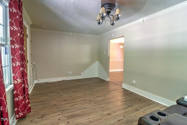 542 Sigman Hollow Rd, Bluff City, TN 37618 - empty room featuring a chandelier, ornamental molding, wood finished floors, and a textured ceiling