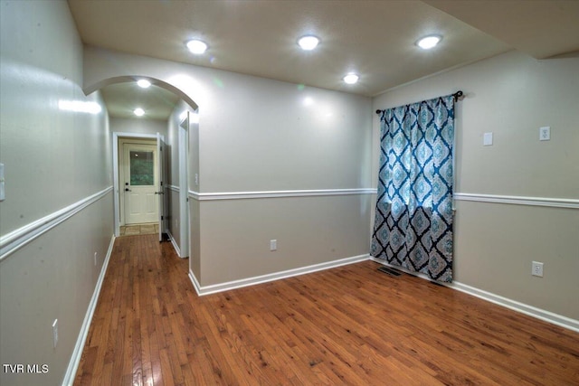 542 Sigman Hollow Rd, Bluff City, TN 37618 - unfurnished room with arched walkways, wood-type flooring, and recessed lighting
